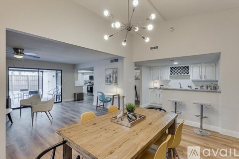 A modern dining room with a wooden table and chairs.
