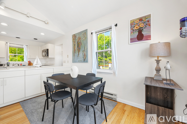 A dining room with a table and chairs.