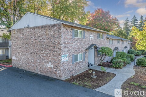 A brick house with a sign that says "Open" on it.