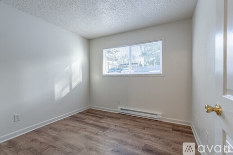 A room with a window and a door.