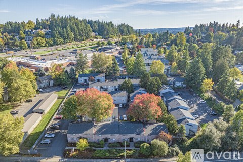 An aerial view of a residential area with houses and trees.