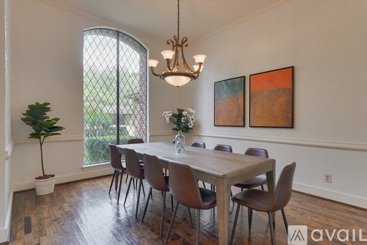 A dining room with a wooden table and chairs.