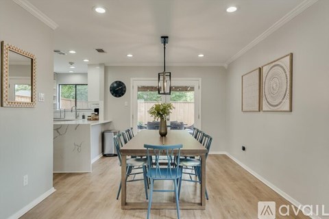 A dining room with a table set for six.