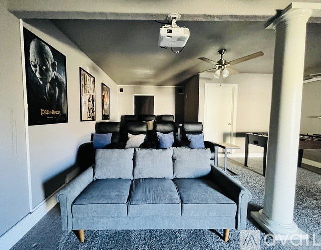 A grey couch with a remote control on it.