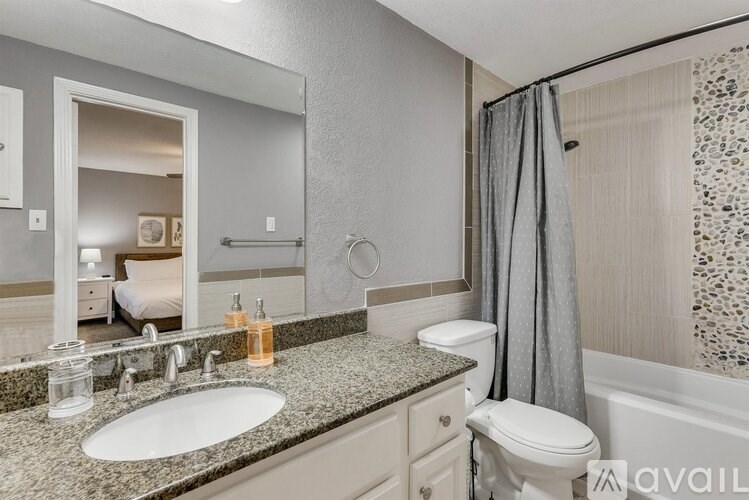 A bathroom with a sink, toilet, and bathtub.