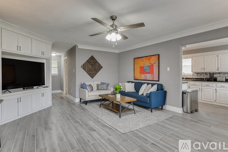 A living room with a blue couch and a television.