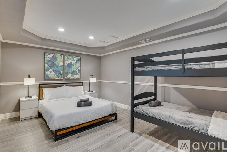 A bedroom with a large bed and a bunk bed.