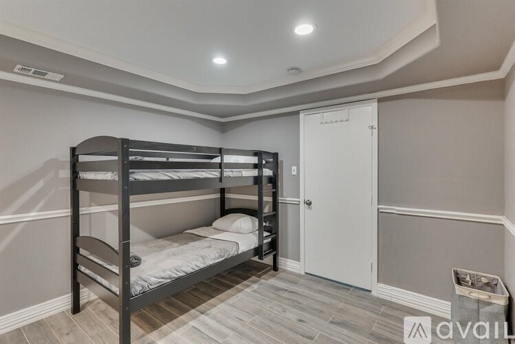 A bedroom with a bunk bed and a small closet.