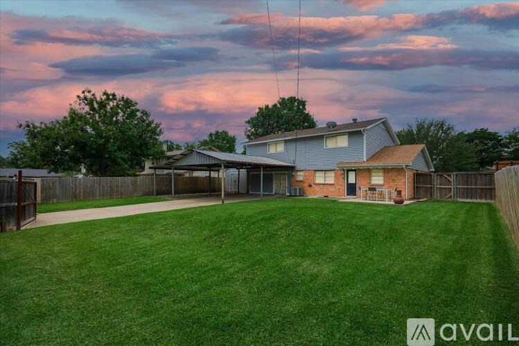 A house with a large lawn is available for sale.