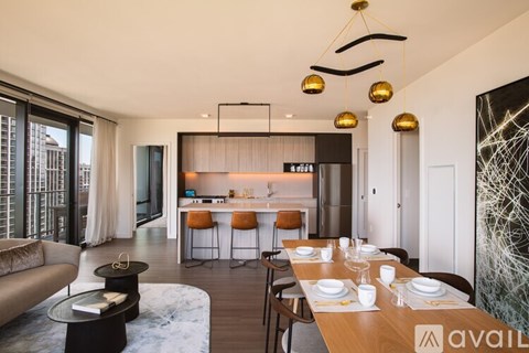 A modern dining room with a long table set for six.