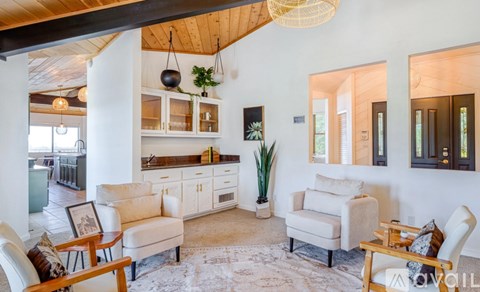 A living room with a white couch and a wooden table.