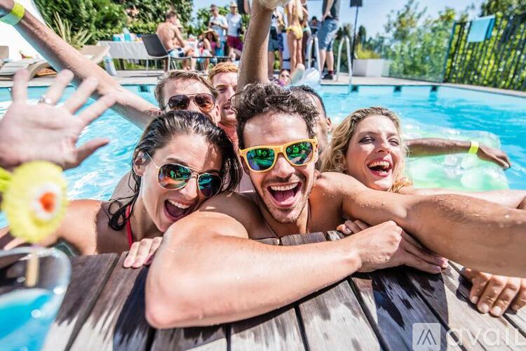 A group of people are enjoying their time in a pool.