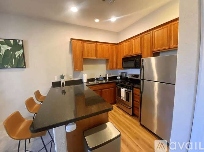 A kitchen with wooden cabinets and stainless steel appliances.
