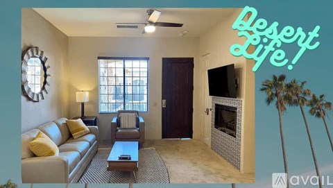 A living room with a couch, chairs, and a television set.