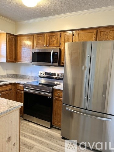 A kitchen with a stainless steel refrigerator and oven.