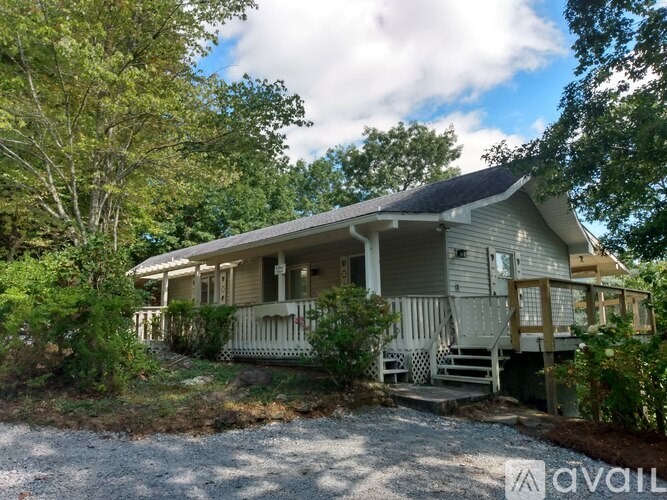 A house with a porch and a front yard.