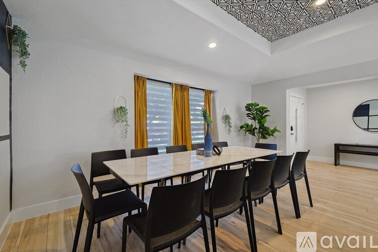 A dining room with a table and chairs.