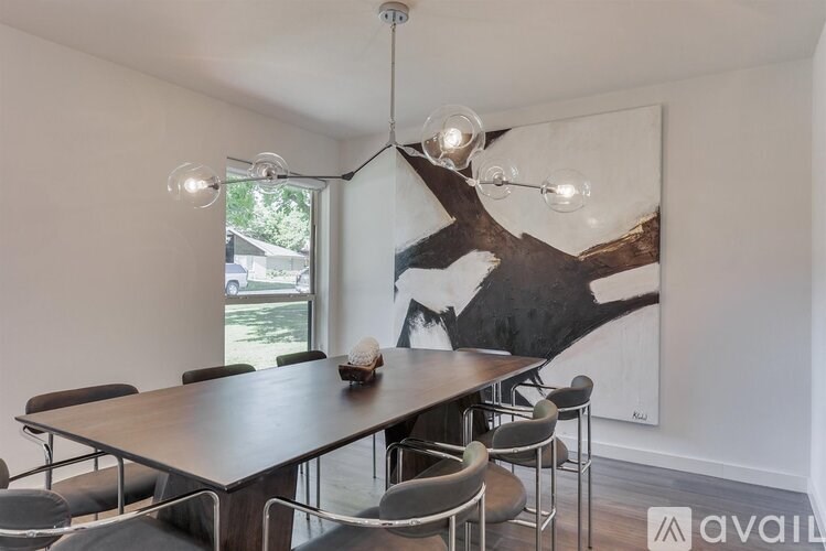 A dining room with a wooden table and chairs.