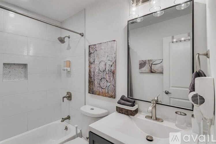 A bathroom with a white tub, toilet, and sink.