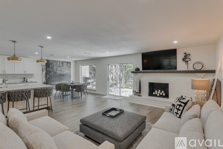 A modern living room with a fireplace and a television.