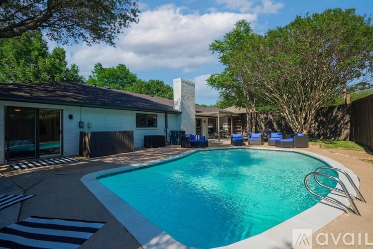 A pool with a white and black striped tile around it.