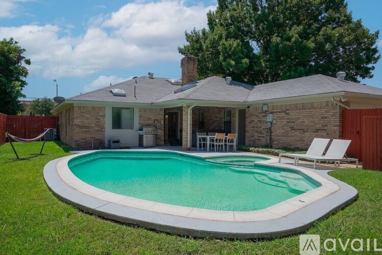 A house with a pool in the backyard.