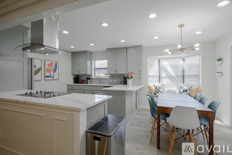 A modern kitchen with a dining table set up.