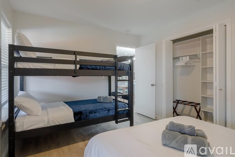 A bedroom with a bunk bed and a single bed.