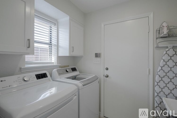 A small laundry room with a washer and dryer.
