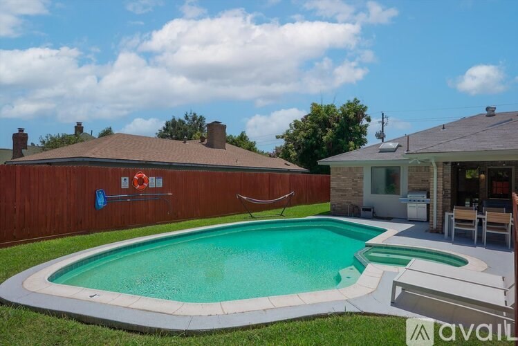 A small residential pool with a white border and a white bench.