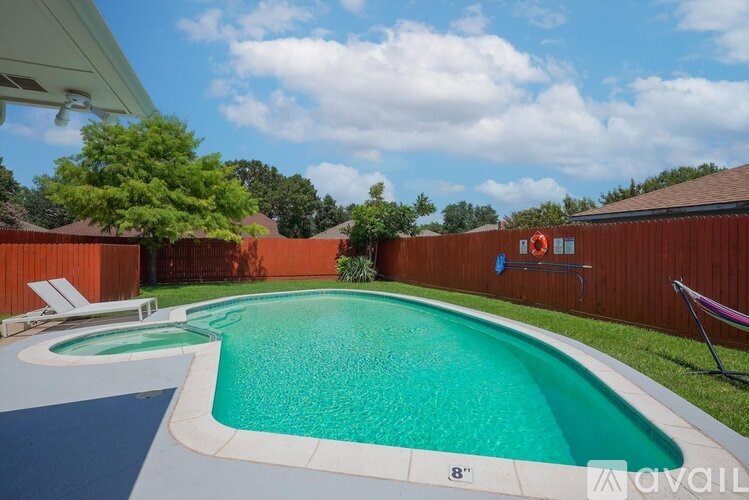 A pool with a blue and green water and a white edge.