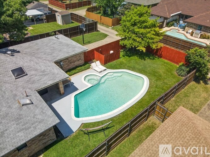 A backyard with a small pool and a deck.