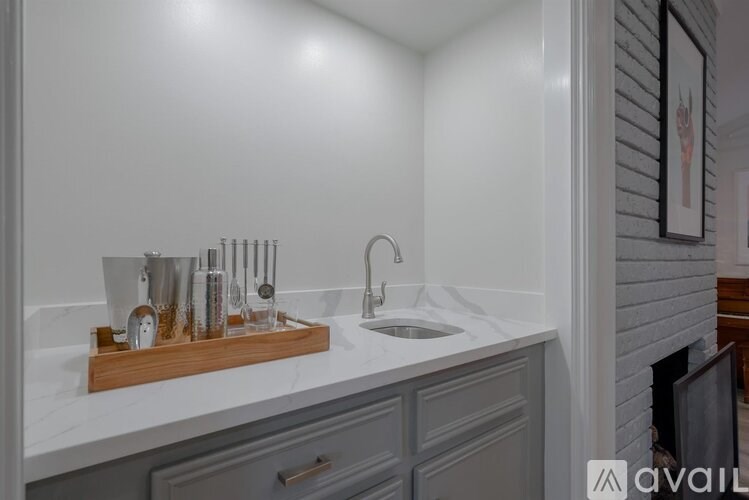 A bathroom sink with a wooden holder and a mirror above it.