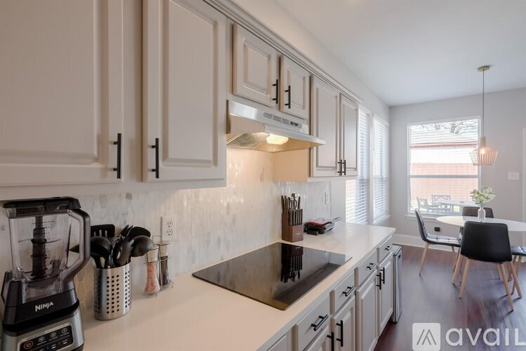 A kitchen with a NutriBullet blender on the counter.