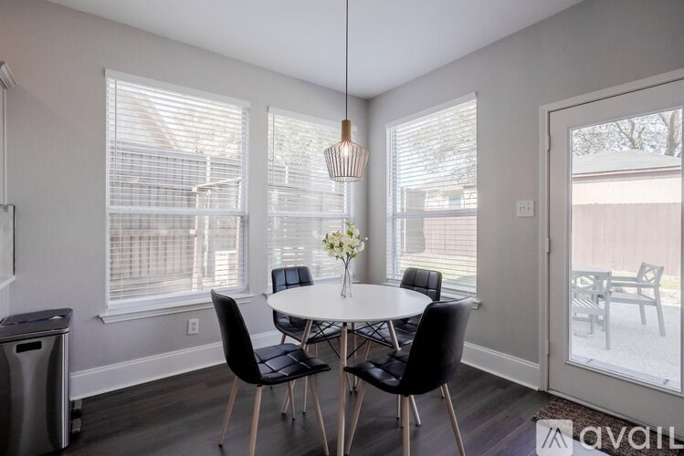 A dining room with a table and chairs.