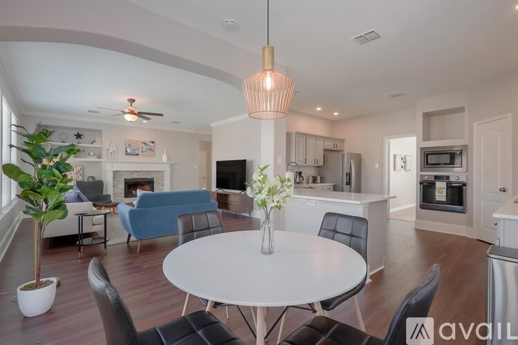 A modern living room with a white table and chairs.