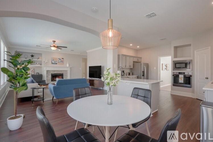 A modern living room with a white table and chairs.