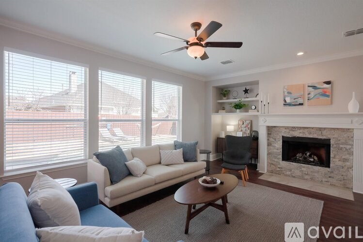 A living room with a couch, a coffee table, and a fireplace.