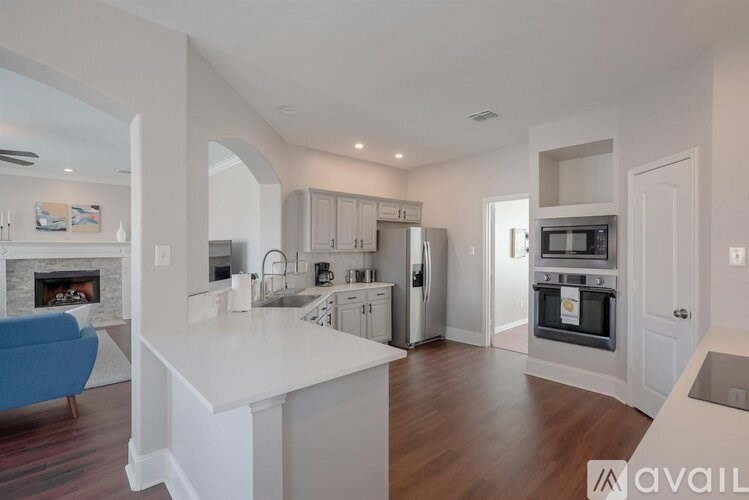 A modern kitchen with a blue sofa and a fireplace.
