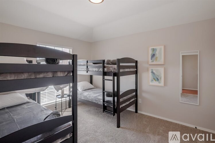 A bedroom with two bunk beds and a window.