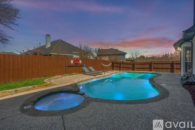 A backyard with a hot tub and a pool.