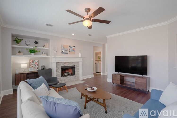 A living room with a fireplace, a television, and a couch.