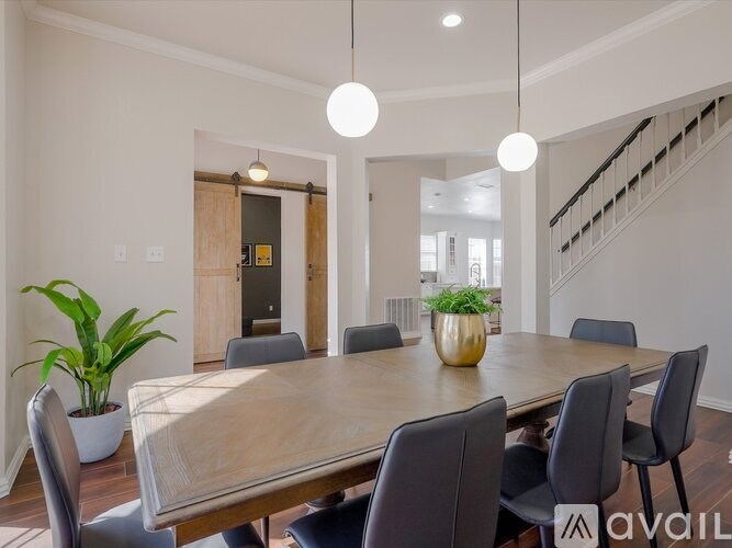 A dining room with a wooden table and chairs.