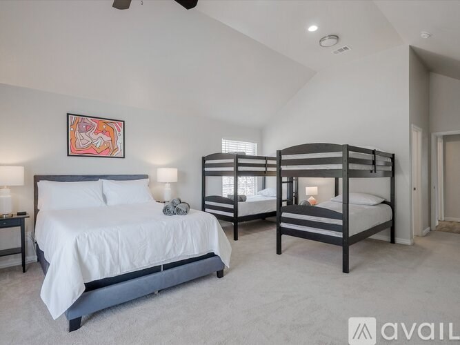 A bedroom with a large bed and a bunk bed.