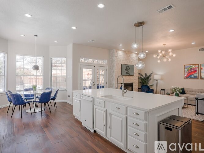 A modern kitchen with white cabinets and a large island.