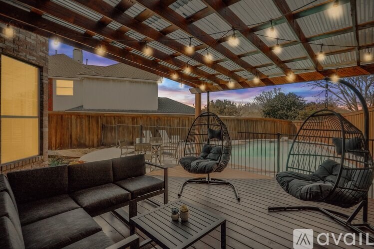 A patio with a couch, chairs, and a table is shown.