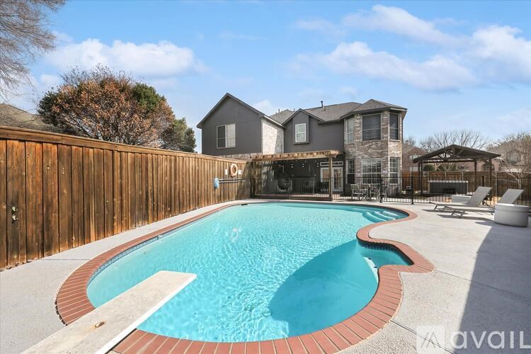 A large backyard with a pool and a house.