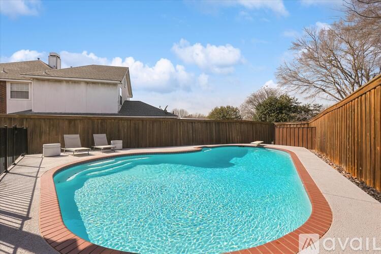 A small pool with a brown border and a white chair.