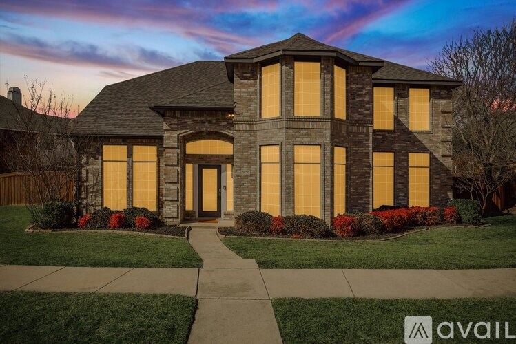 A house with a front yard and a walkway leading to the front door.