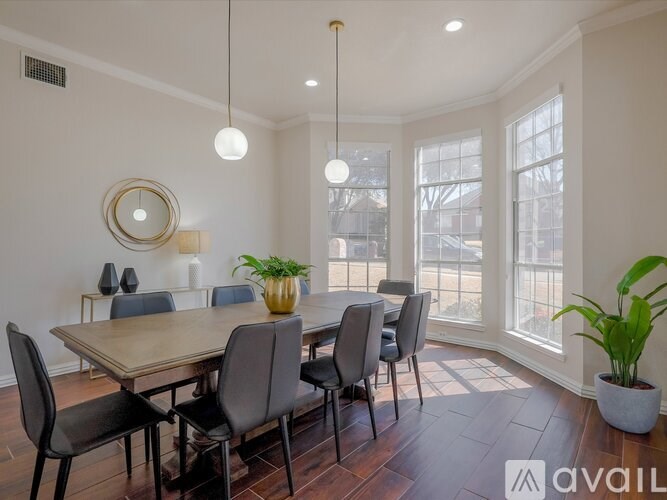 A dining room with a wooden table and chairs.